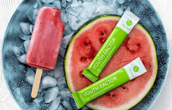 Lifestyle shot of Youth Factor® Superfood & Antioxidant Boost Powder sitting on a piece of watermelon.